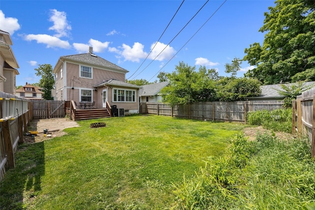 1812 Blake Blvd SE, Cedar Rapids, IA 52403 - back of property with a fenced backyard, a wooden deck, and a chimney