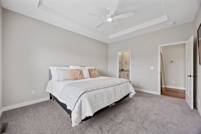 6415 Rookwood Ln, Marion, IA 52302 - carpeted bedroom with a raised ceiling, a ceiling fan, and ensuite bathroom