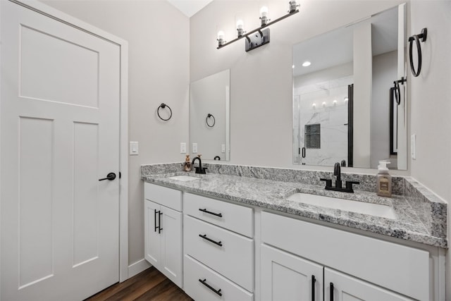 6415 Rookwood Ln, Marion, IA 52302 - full bathroom with a shower stall, double vanity, and wood finished floors