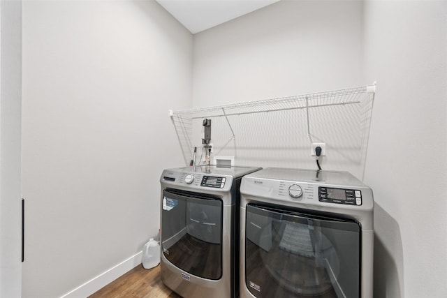 6415 Rookwood Ln, Marion, IA 52302 - washroom featuring washer and dryer and wood finished floors