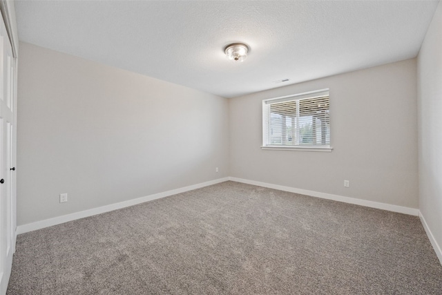 6415 Rookwood Ln, Marion, IA 52302 - carpeted spare room featuring baseboards and a textured ceiling