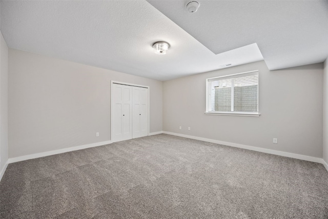 6415 Rookwood Ln, Marion, IA 52302 - unfurnished bedroom featuring carpet, a closet, and a textured ceiling