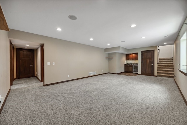 450 2nd St, Fairfax, IA 52228 - unfurnished living room with recessed lighting, stairway, bar, light colored carpet, and wine cooler