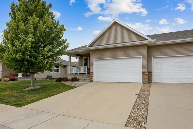 450 2nd St, Fairfax, IA 52228 - ranch-style house with a front lawn, stone siding, concrete driveway, an attached garage, and a shingled roof