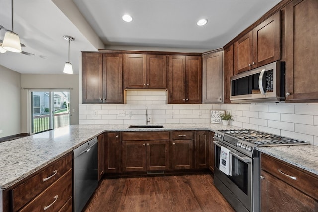 450 2nd St, Fairfax, IA 52228 - kitchen with appliances with stainless steel finishes, dark wood-style flooring, a peninsula, backsplash, and recessed lighting