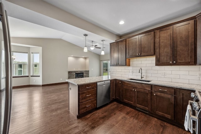 450 2nd St, Fairfax, IA 52228 - kitchen with stainless steel appliances, a ceiling fan, a stone fireplace, dark brown cabinetry, and lofted ceiling