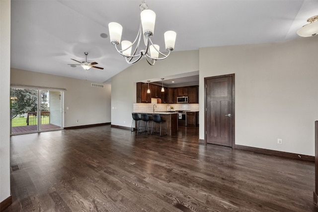 450 2nd St, Fairfax, IA 52228 - unfurnished living room with ceiling fan, vaulted ceiling, dark wood-style flooring, and a chandelier