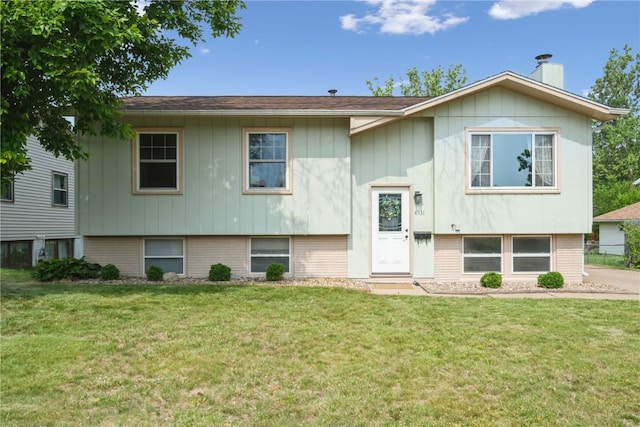 4531 Sugar Pine Dr NE, Cedar Rapids, IA 52402 - bi-level home with a front yard, brick siding, and a chimney