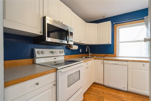 4531 Sugar Pine Dr NE, Cedar Rapids, IA 52402 - kitchen with white appliances, white cabinetry, light wood-style flooring, and light countertops