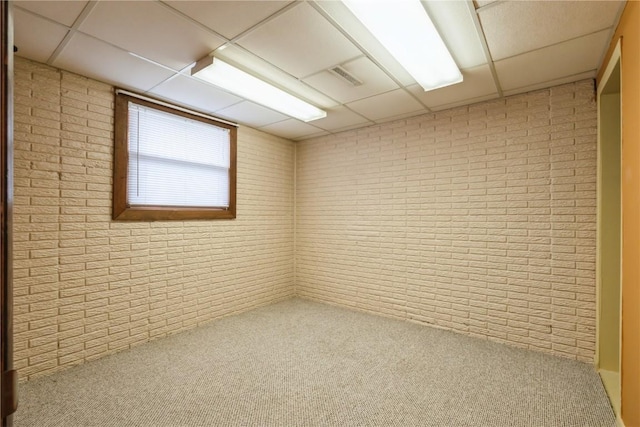 4531 Sugar Pine Dr NE, Cedar Rapids, IA 52402 - spare room with brick wall, a drop ceiling, and carpet flooring