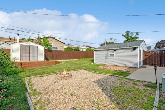 5515 Cedar Dr NW, Cedar Rapids, IA 52405 - fenced backyard featuring a fire pit, an outbuilding, and a patio