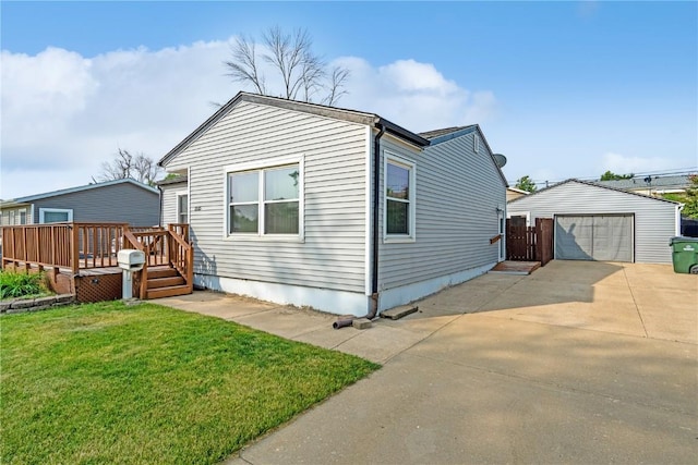 5515 Cedar Dr NW, Cedar Rapids, IA 52405 - view of front facade featuring a wooden deck, an outbuilding, a garage, a front yard, and driveway