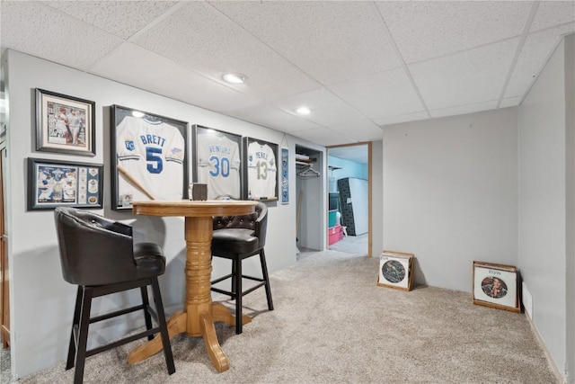 5515 Cedar Dr NW, Cedar Rapids, IA 52405 - bar area with carpet flooring and a paneled ceiling
