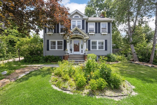 362 Garden Dr SE, Cedar Rapids, IA 52403 - view of front of home with a front lawn and a chimney