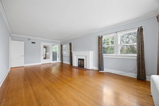 362 Garden Dr SE, Cedar Rapids, IA 52403 - unfurnished living room featuring wood finished floors, a fireplace, crown molding, and radiator