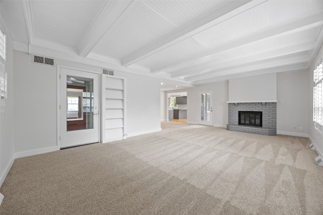 362 Garden Dr SE, Cedar Rapids, IA 52403 - unfurnished living room with carpet floors, beamed ceiling, and a brick fireplace