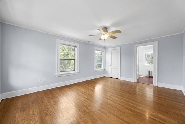362 Garden Dr SE, Cedar Rapids, IA 52403 - unfurnished bedroom with radiator, ornamental molding, wood finished floors, a ceiling fan, and ensuite bathroom