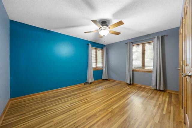 2030 26th St, Marion, IA 52302 - empty room with ceiling fan, wood finished floors, and a textured ceiling