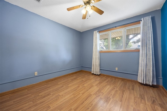 2030 26th St, Marion, IA 52302 - unfurnished room featuring wood finished floors, ceiling fan, and a baseboard radiator