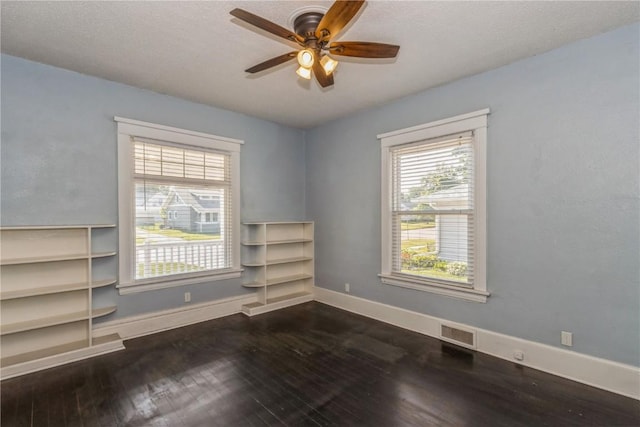 1346 11th St, Marion, IA 52302 - empty room with dark wood finished floors and ceiling fan