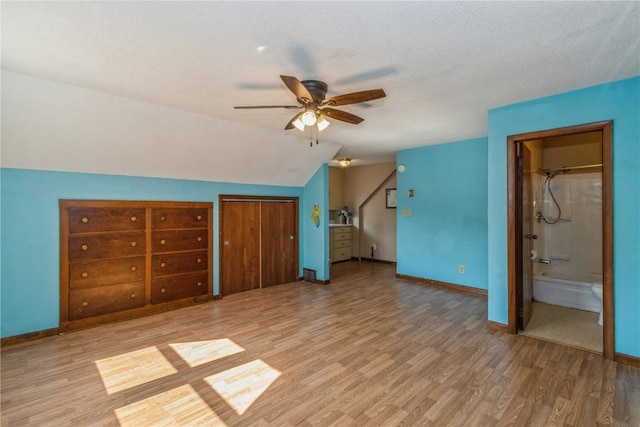 1346 11th St, Marion, IA 52302 - bonus room featuring wood finished floors, a ceiling fan, a textured ceiling, and vaulted ceiling