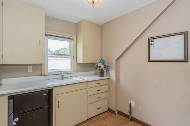 1346 11th St, Marion, IA 52302 - kitchen with light countertops, light wood finished floors, and cream cabinetry