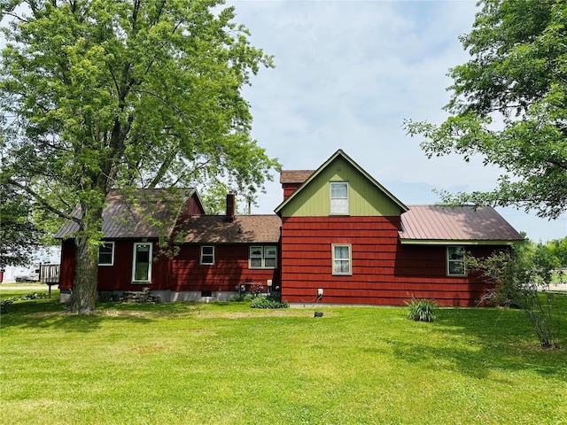 109 Pine St NW, Blairstown, IA 52209 - rear view of house featuring a yard and a chimney