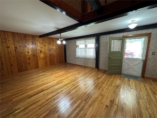 109 Pine St NW, Blairstown, IA 52209 - entryway featuring wallpapered walls, light wood-style flooring, and beam ceiling