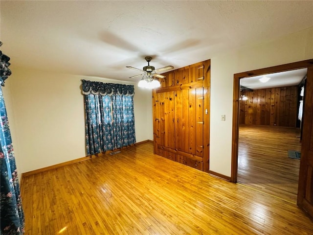 109 Pine St NW, Blairstown, IA 52209 - unfurnished room featuring wood-type flooring and ceiling fan