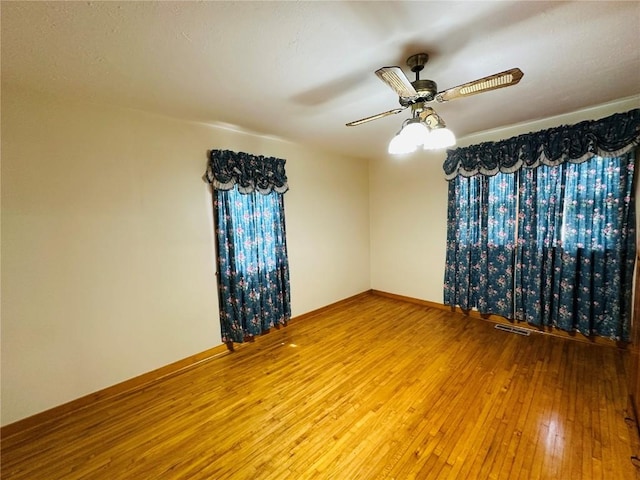 109 Pine St NW, Blairstown, IA 52209 - empty room with hardwood / wood-style flooring and ceiling fan
