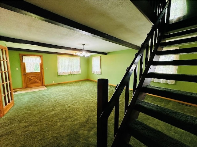 109 Pine St NW, Blairstown, IA 52209 - stairs featuring carpet floors, a chandelier, beam ceiling, and a textured ceiling