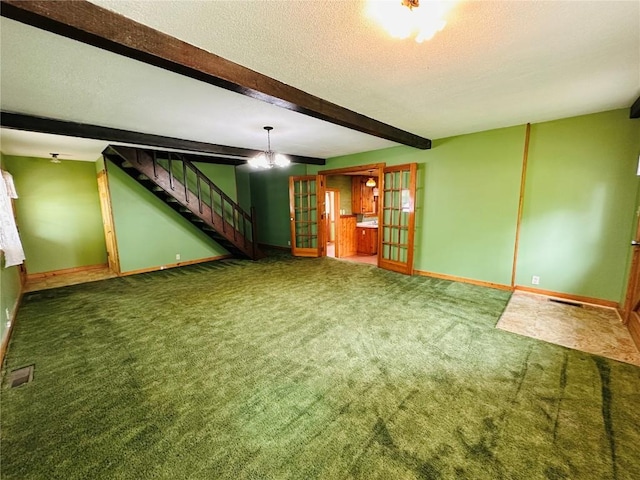 109 Pine St NW, Blairstown, IA 52209 - below grade area with carpet flooring, stairway, a textured ceiling, a chandelier, and french doors