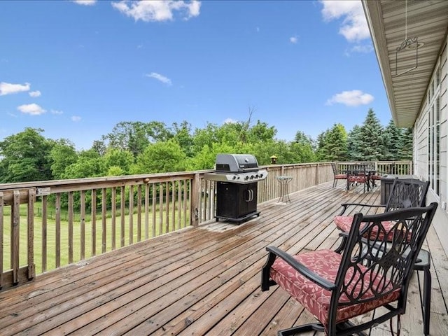 3387 64th St, Palo, IA 52324 - wooden deck with a grill, outdoor dining space, a yard, and view of wooded area
