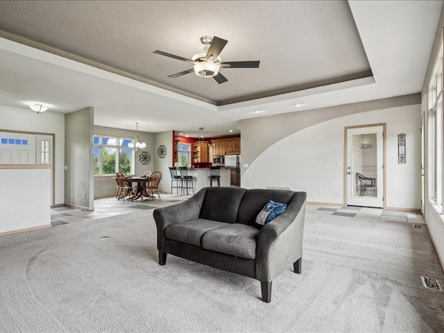 3387 64th St, Palo, IA 52324 - living room with a raised ceiling, light carpet, a ceiling fan, a chandelier, and recessed lighting