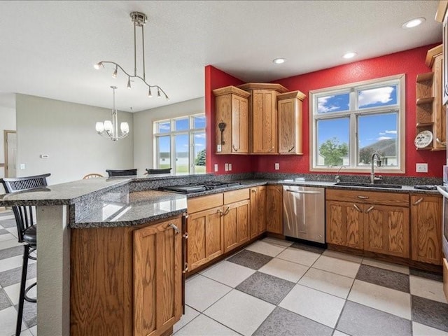 3387 64th St, Palo, IA 52324 - kitchen featuring appliances with stainless steel finishes, a peninsula, a kitchen breakfast bar, brown cabinetry, and recessed lighting