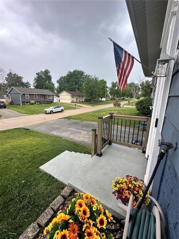 6706 Boxwood Ln NE, Cedar Rapids, IA 52402 - view of grassy yard featuring a porch