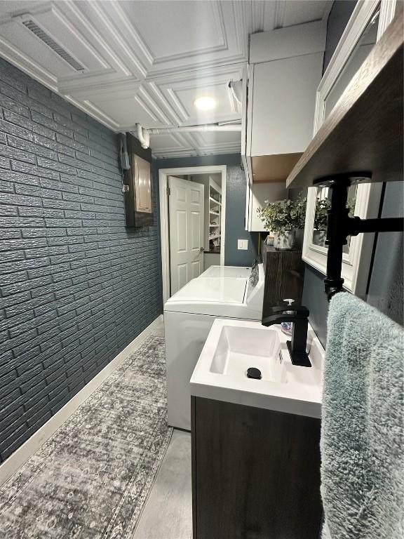6706 Boxwood Ln NE, Cedar Rapids, IA 52402 - bathroom with vanity, electric panel, and washer and clothes dryer