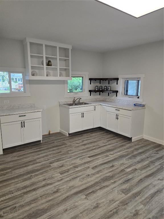 314 Main St, Oxford Junction, IA 52323 - kitchen with open shelves, plenty of natural light, white cabinets, and dark wood-type flooring