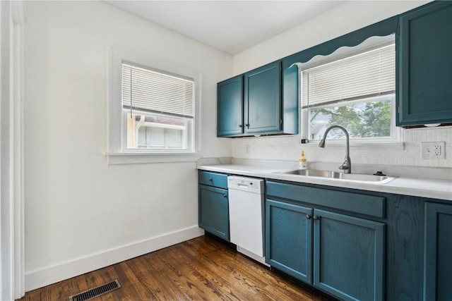 1612 Greene Ave NE, Cedar Rapids, IA 52402 - kitchen with dishwasher, blue cabinetry, backsplash, and light countertops