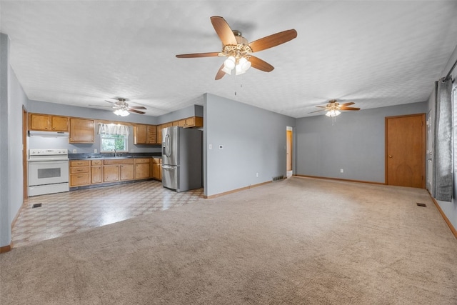 203 B Ave, Newhall, IA 52315 - kitchen with stainless steel refrigerator with ice dispenser, white electric range, dark countertops, a ceiling fan, and a textured ceiling