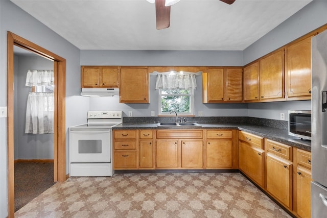 203 B Ave, Newhall, IA 52315 - kitchen with white electric range, under cabinet range hood, light flooring, ceiling fan, and brown cabinetry