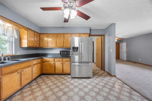 203 B Ave, Newhall, IA 52315 - kitchen with appliances with stainless steel finishes, ceiling fan, light floors, and dark countertops