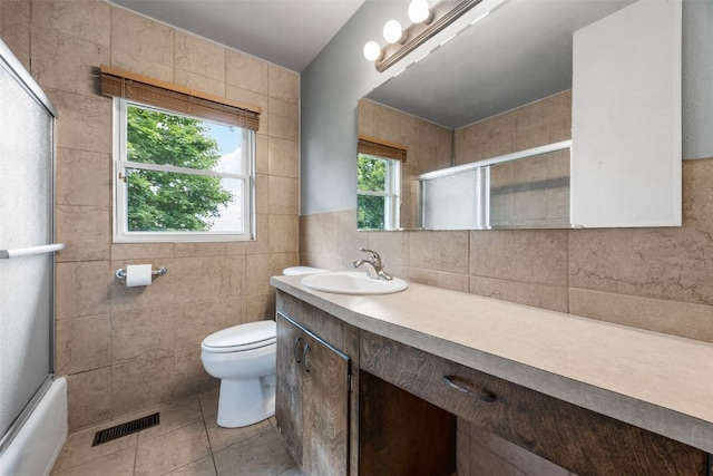 203 B Ave, Newhall, IA 52315 - full bath with tile walls, vanity, tile patterned floors, and enclosed tub / shower combo