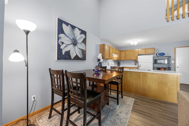 3810 Waterview Ct SW, Cedar Rapids, IA 52404 - dining room featuring wood finished floors and a towering ceiling