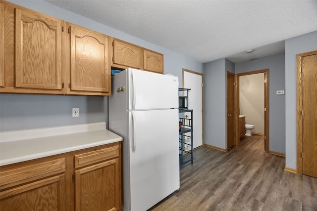 3810 Waterview Ct SW, Cedar Rapids, IA 52404 - kitchen with freestanding refrigerator, wood finished floors, light countertops, and a textured ceiling