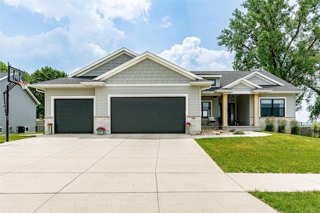 608 Pointer Cir, Center Point, IA 52213 - craftsman house featuring a garage, a front lawn, concrete driveway, stone siding, and covered porch