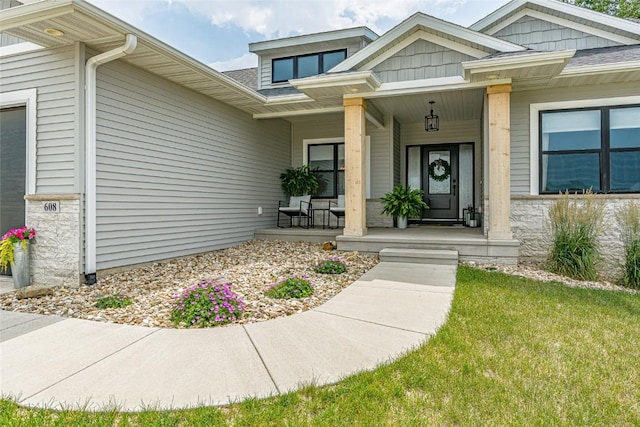 608 Pointer Cir, Center Point, IA 52213 - doorway to property featuring covered porch and roof with shingles