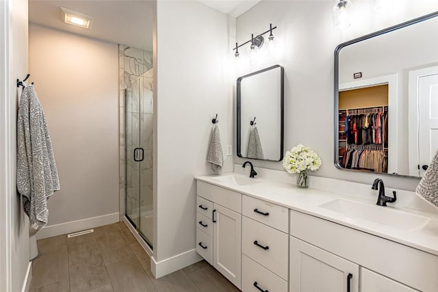 608 Pointer Cir, Center Point, IA 52213 - full bathroom with double vanity, a shower stall, and a spacious closet