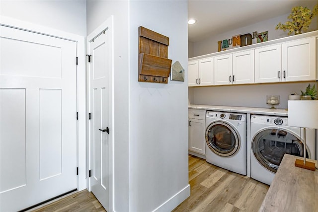 608 Pointer Cir, Center Point, IA 52213 - laundry area featuring washer and clothes dryer, light wood-style flooring, cabinet space, and recessed lighting