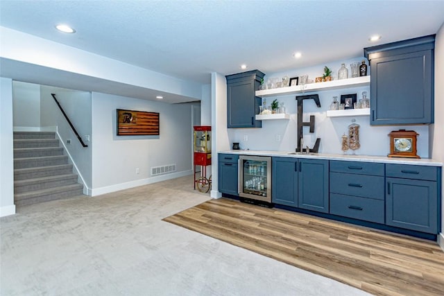 608 Pointer Cir, Center Point, IA 52213 - indoor wet bar featuring wine cooler, stairway, recessed lighting, and light colored carpet